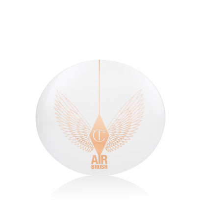 A closed, setting powder compact with a white-coloured lid with golden-coloured wings on it.