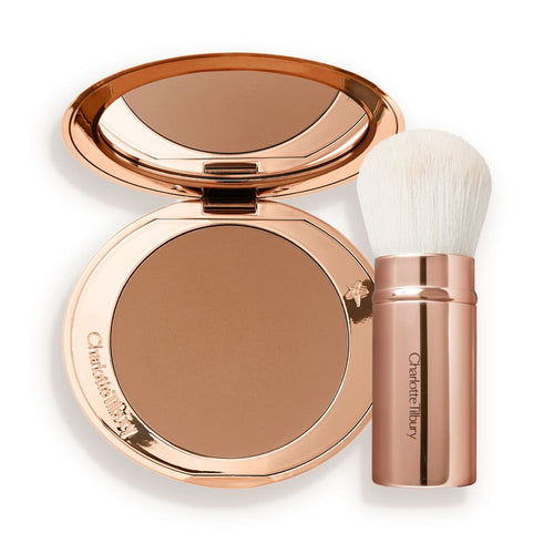 An open bronzer compact in a light brown shade and a kabuki brush with white-coloured bristles and a gold-coloured handle.