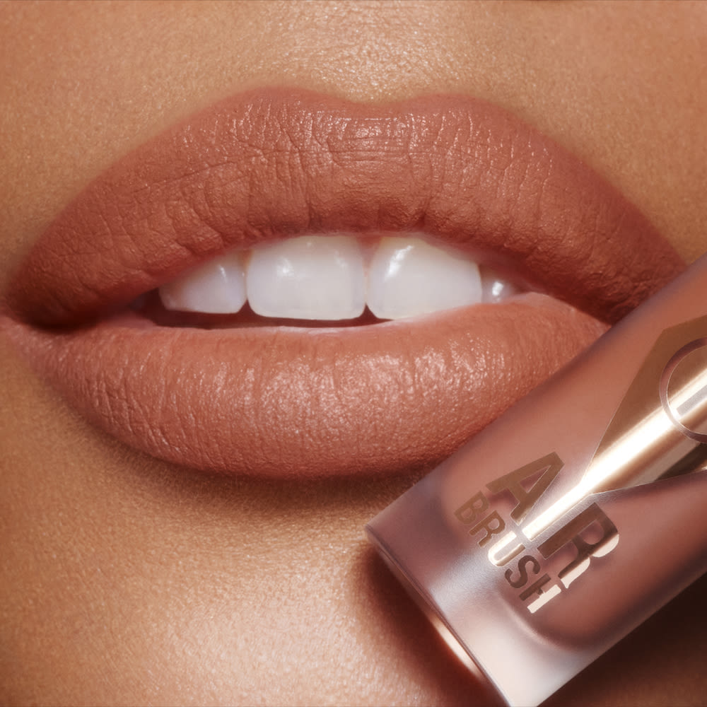 Airbrush Flawless Lip Blur in Nude close up on a medium skin tone model