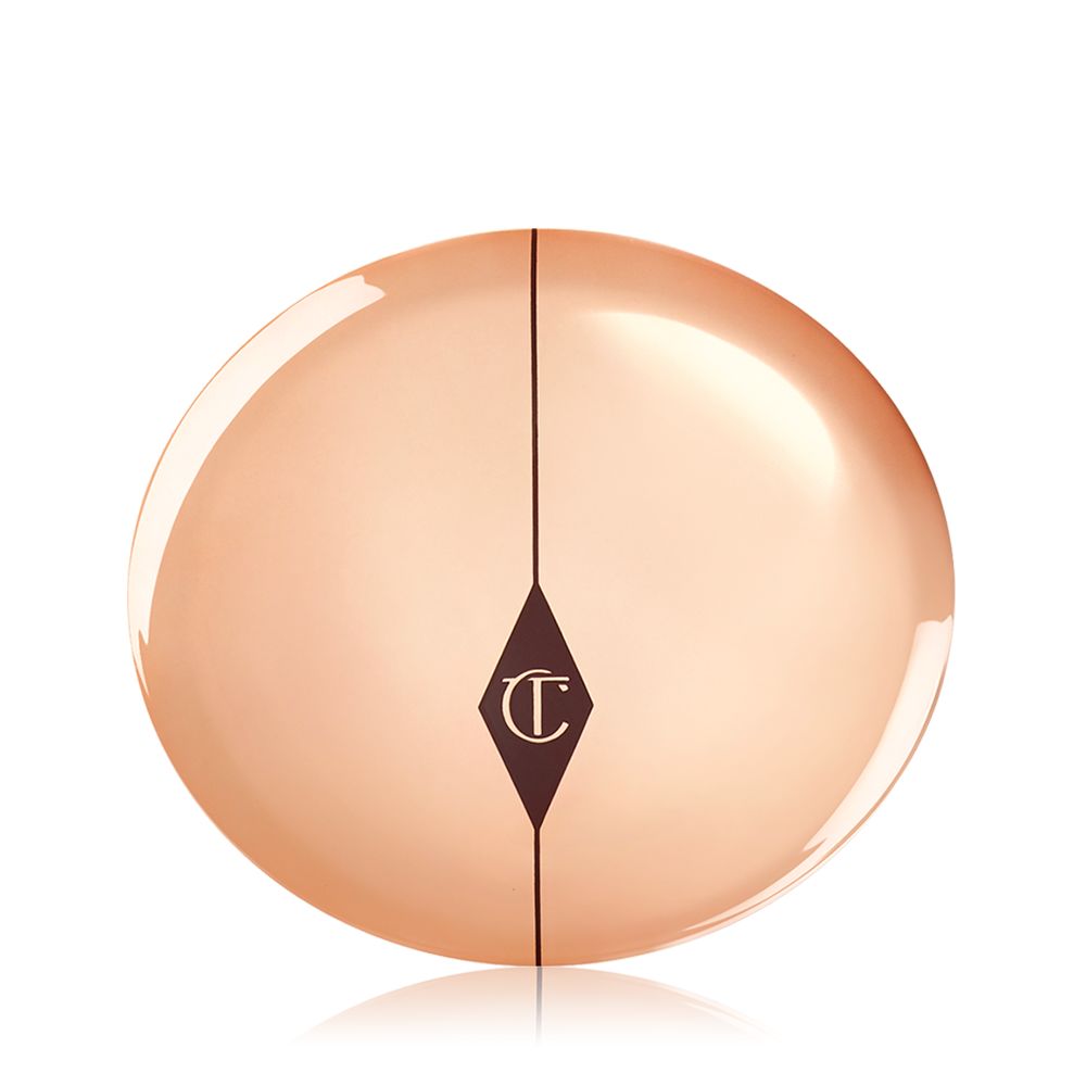 A closed powder compact with gold-coloured packaging and the CT logo printed on the lid in a dark brown and gold colour.