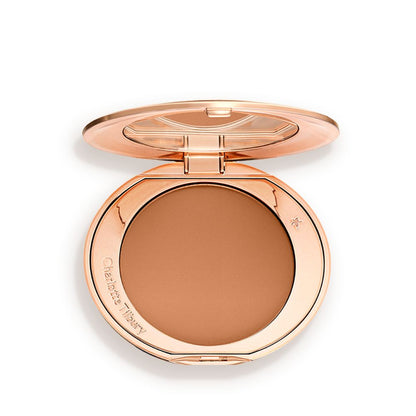 An open, pressed powder compact in a dark brown shade.