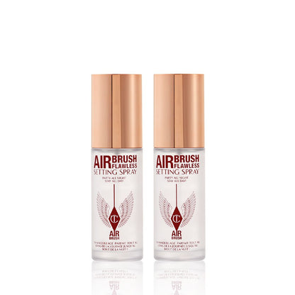 Two, identical, mini, setting sprays in clear bottles with gold-coloured lids.