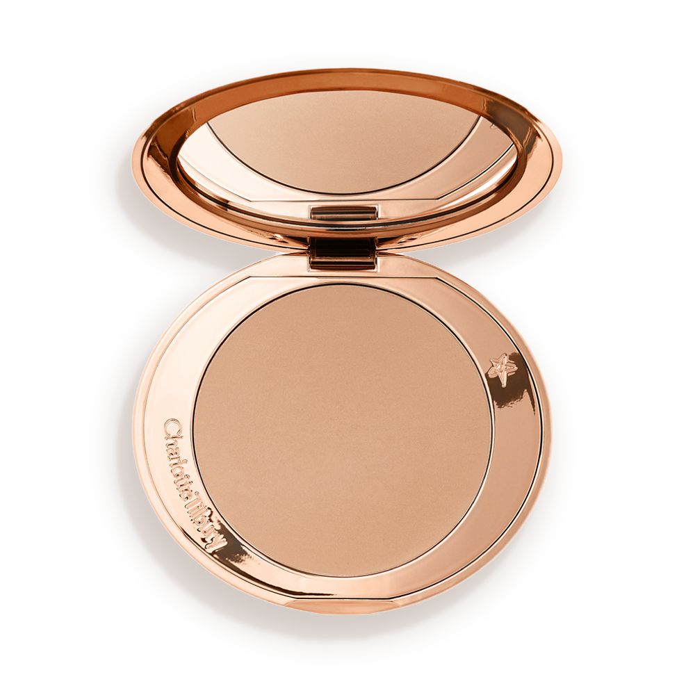 An open mirrored-lid bronzer compact in a light shade.