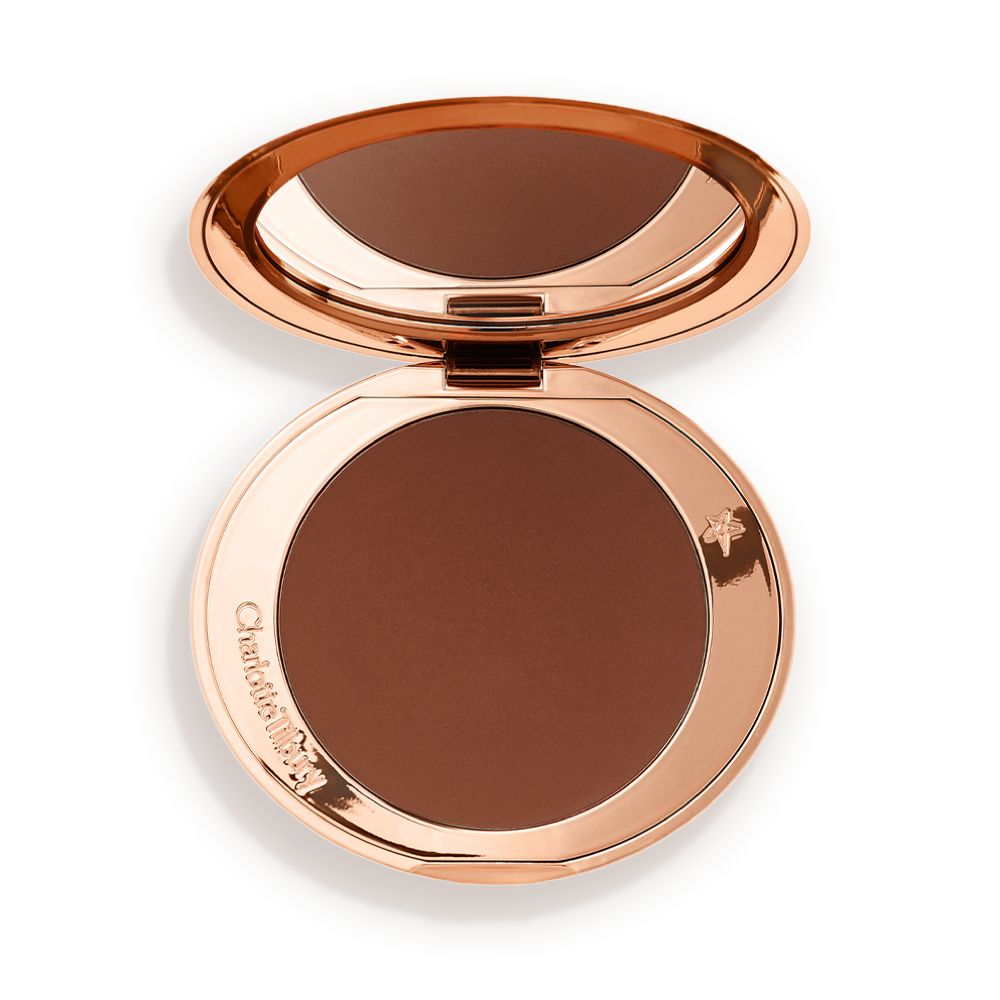 An open mirrored-lid bronzer compact in a dark brown shade.