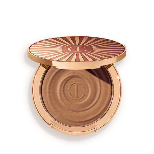 Open, cream bronzer compact in a light-sandy-brown shade with gold-coloured packaging.