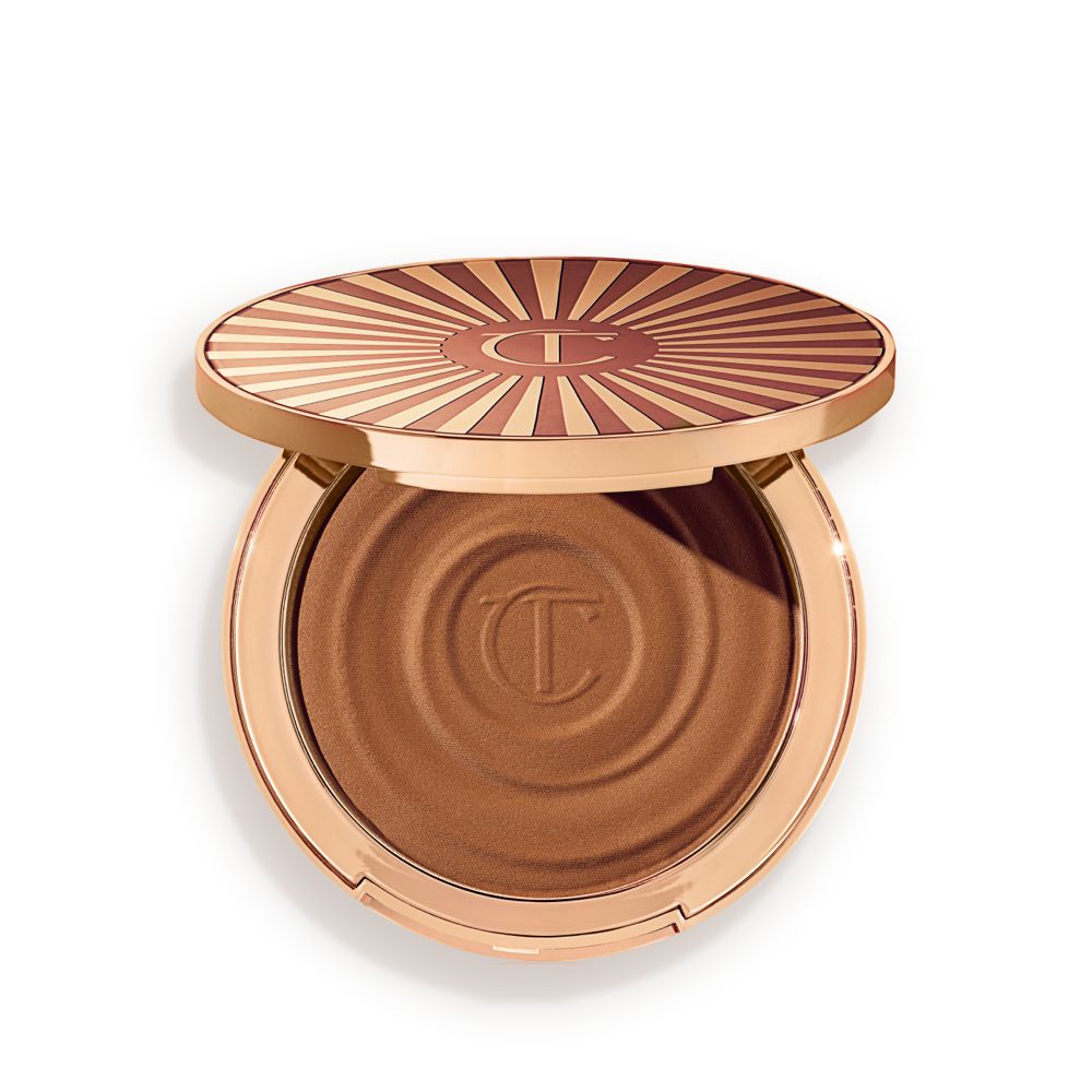 Open, cream bronzer compact in a medium-brown shade with gold-coloured packaging.