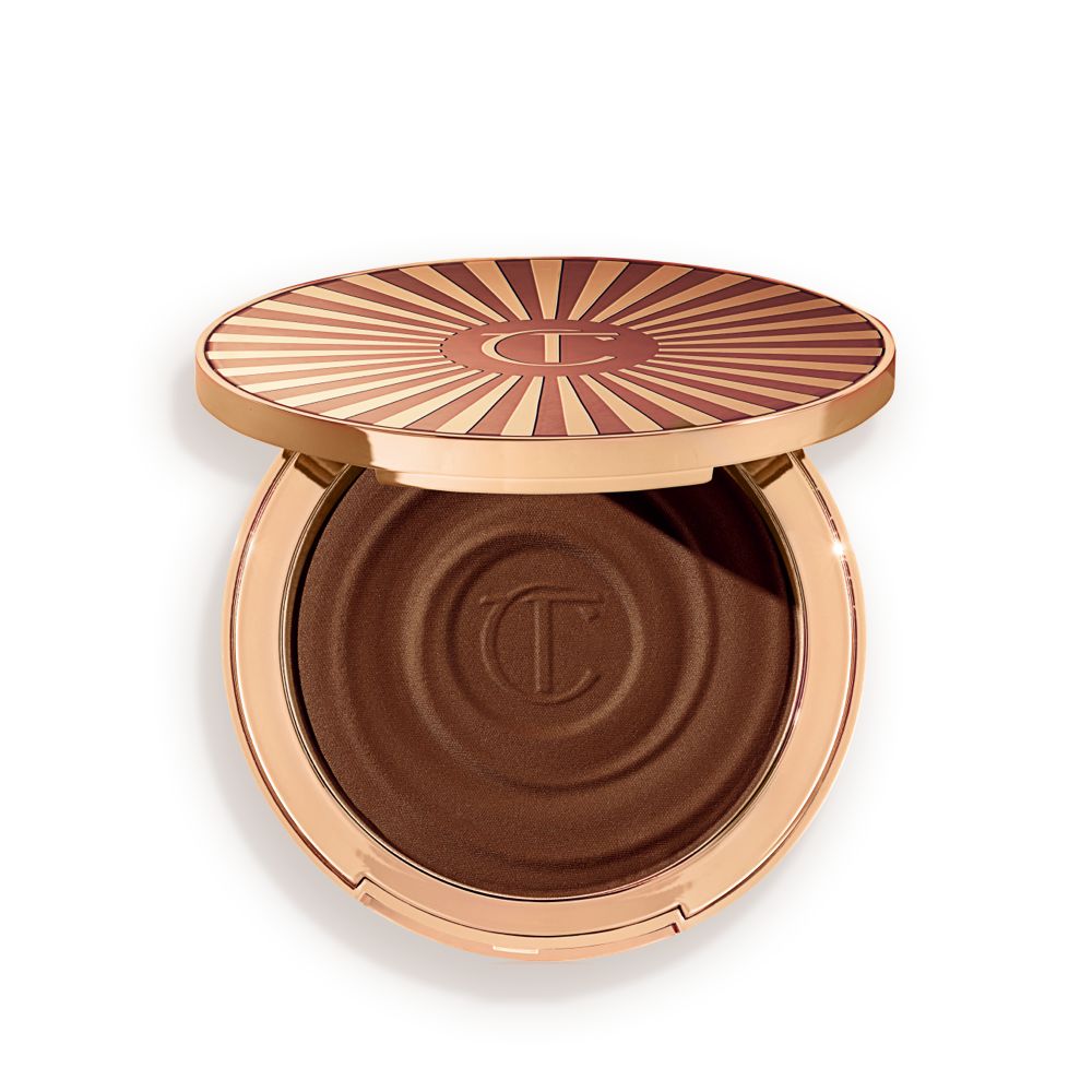 Open, cream bronzer compact in a black-brown shade with gold-coloured packaging.