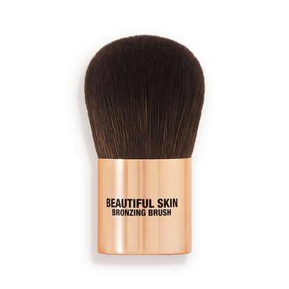 A bronzer brush with soft, dark brown synthetic bristles and a golden-coloured handle, perfect for both cream and powder bronzers.
