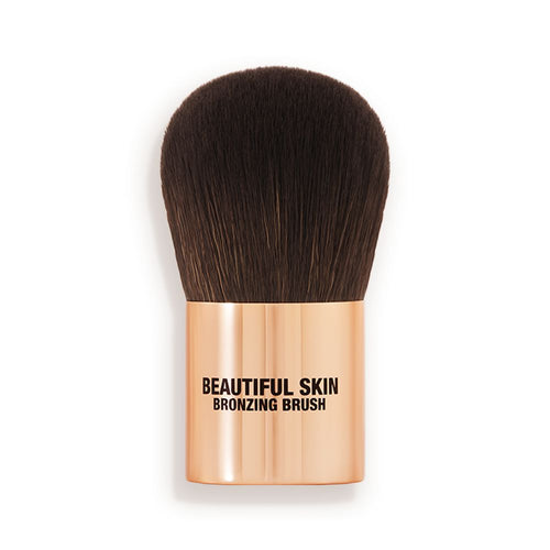 A bronzer brush with soft, dark brown synthetic bristles and a golden-coloured handle, perfect for both cream and powder bronzers.