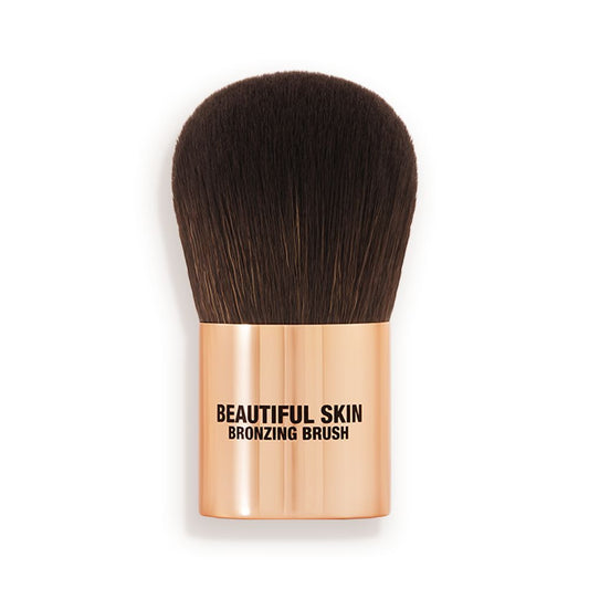 A bronzer brush with soft, dark brown synthetic bristles and a golden-coloured handle, perfect for both cream and powder bronzers.