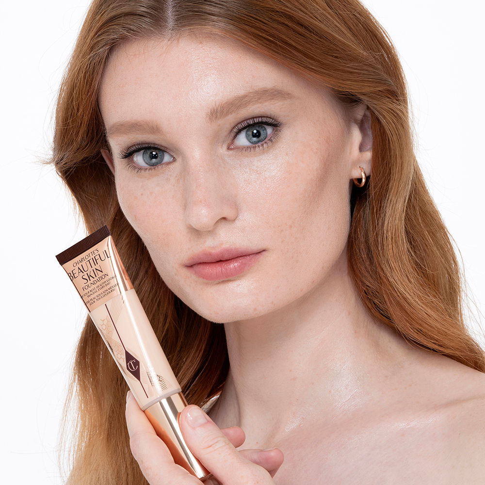 Fair-tone model with glowy, flawless skin, wearing skin-like foundation that adds a youthful glow and looks natural along with nude pink lipstick and subtle everyday eye makeup.