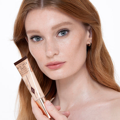Fair-tone model with glowy, flawless skin, wearing skin-like foundation that adds a youthful glow and looks natural along with nude pink lipstick and subtle everyday eye makeup.