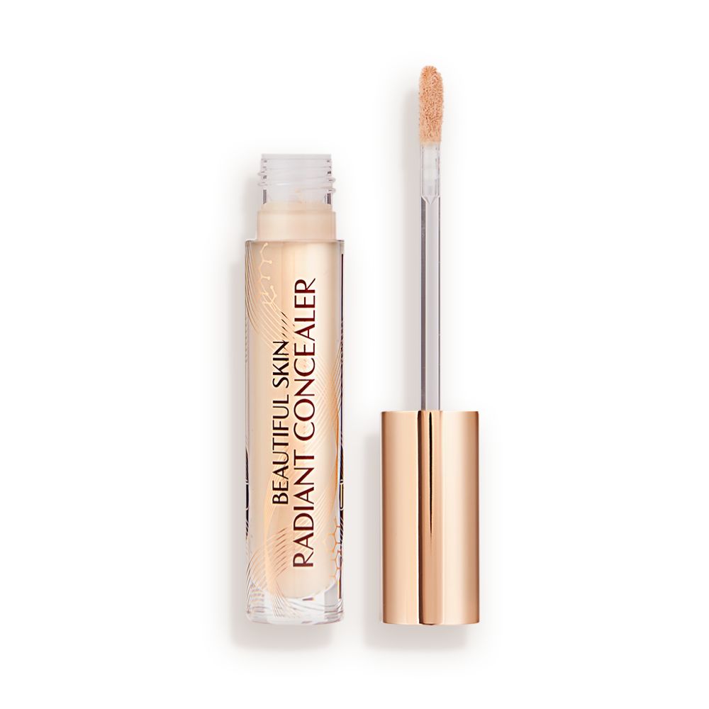 Radiant concealer in a glass tube with its doe-foot applicator next to it with a gold-coloured handle.