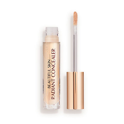 Radiant concealer in a glass tube with its doe-foot applicator next to it with a gold-coloured handle.