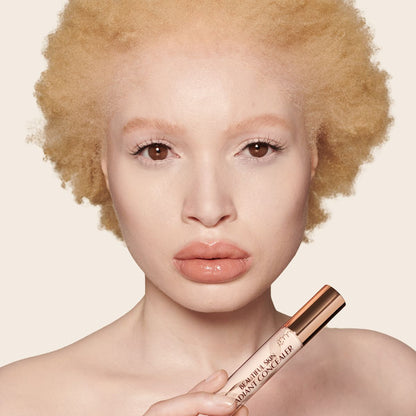 Fair-tone model wearing a radiant, skin-like concealer that covers her freckles, wrinkles, and dark circles, and makes her look fresh and youthful.