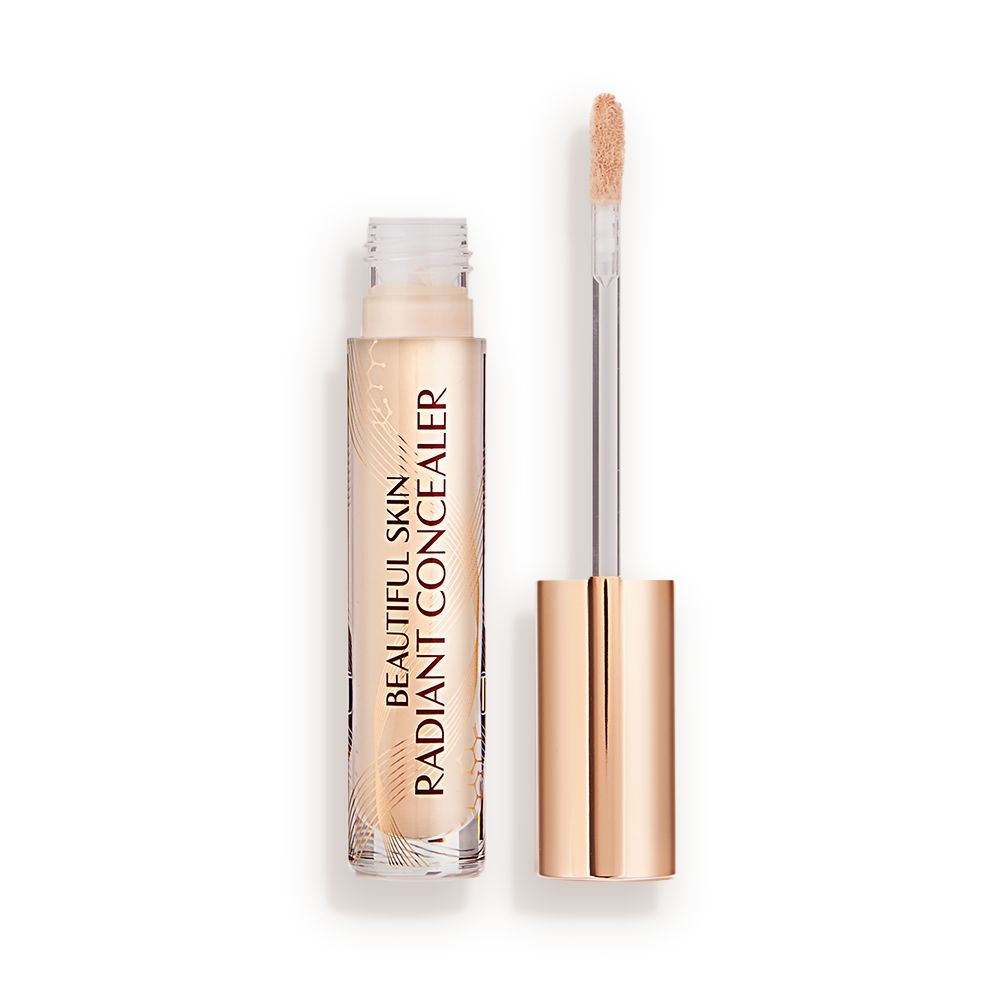 Radiant concealer in a glass tube with its doe-foot applicator next to it with a gold-coloured handle.