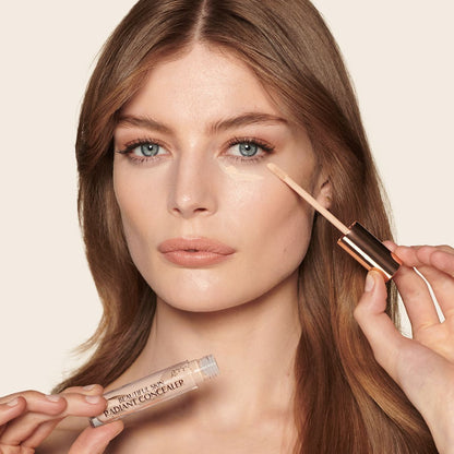 Fair-tone model with blue eyes wearing a radiant, concealer that brightens, covers blemishes, and makes her skin look fresh along with nude lip gloss and subtle eye makeup.