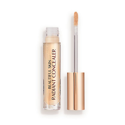 Radiant concealer in a glass tube with its doe-foot applicator next to it with a gold-coloured handle.