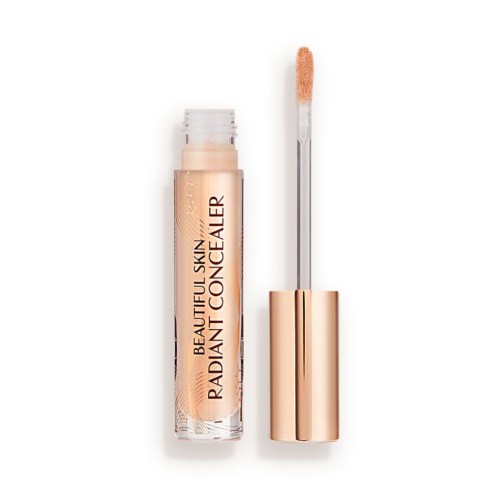 Radiant concealer in a glass tube with its doe-foot applicator next to it with a gold-coloured handle.