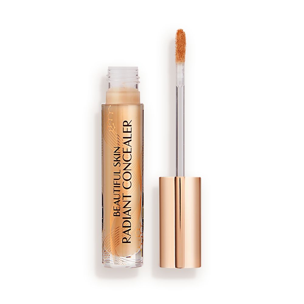 Radiant concealer in a glass tube with its doe-foot applicator next to it with a gold-coloured handle.