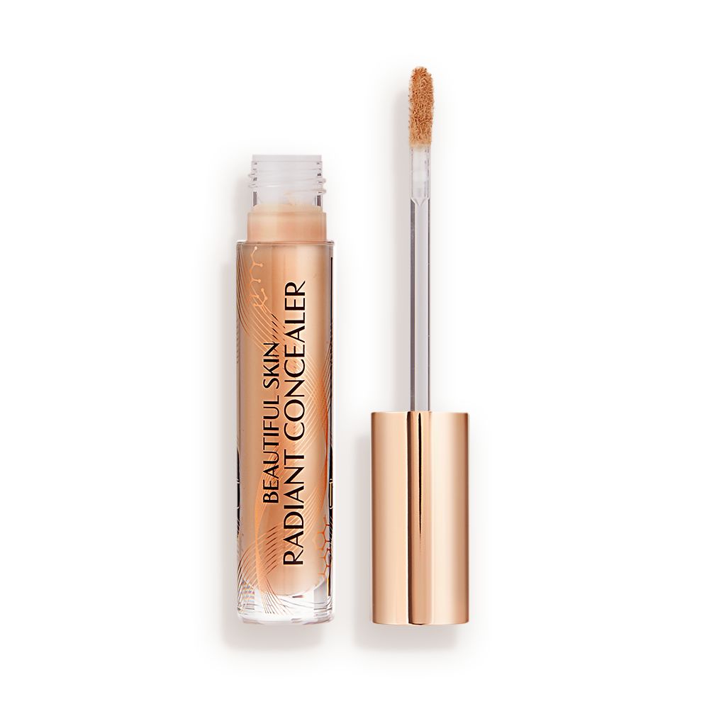 Radiant concealer in a glass tube with its doe-foot applicator next to it with a gold-coloured handle.
