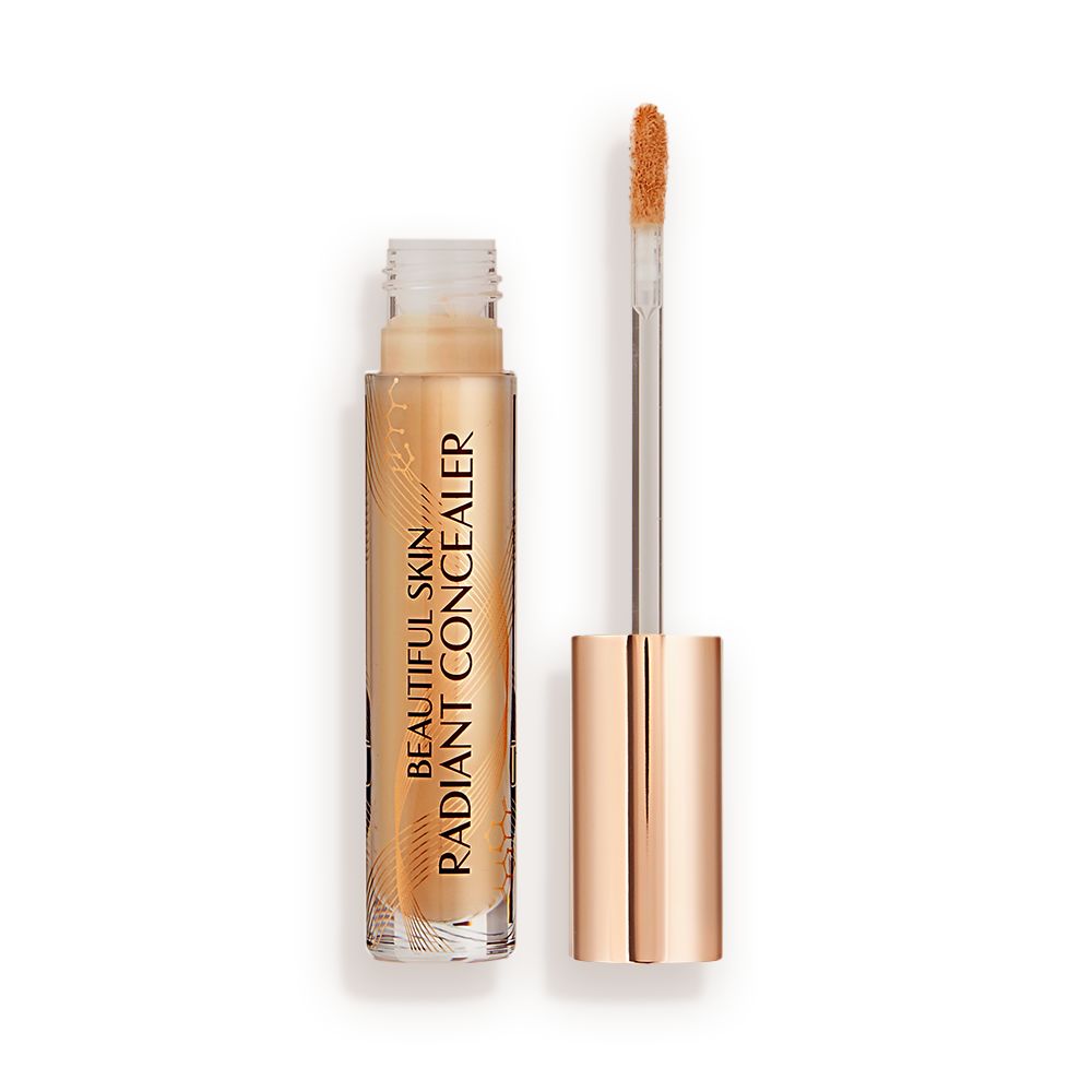 Radiant concealer in a glass tube with its doe-foot applicator next to it with a gold-coloured handle.