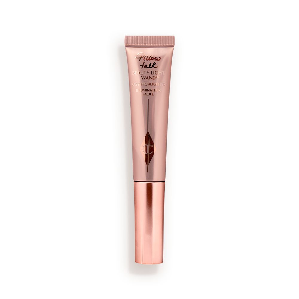 Liquid highlighter wand in a reflective, pale pink tube with a rose gold cap.