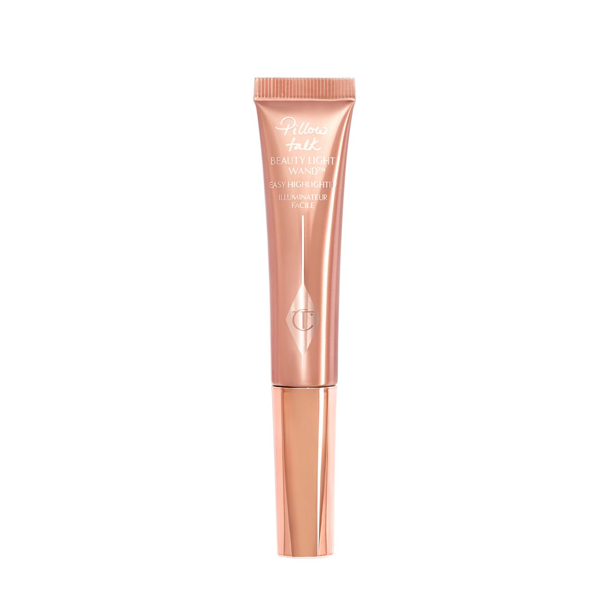 A liquid highlighter wand in a pearlescent rose-gold plastic tube with its nude-pink box next to it.