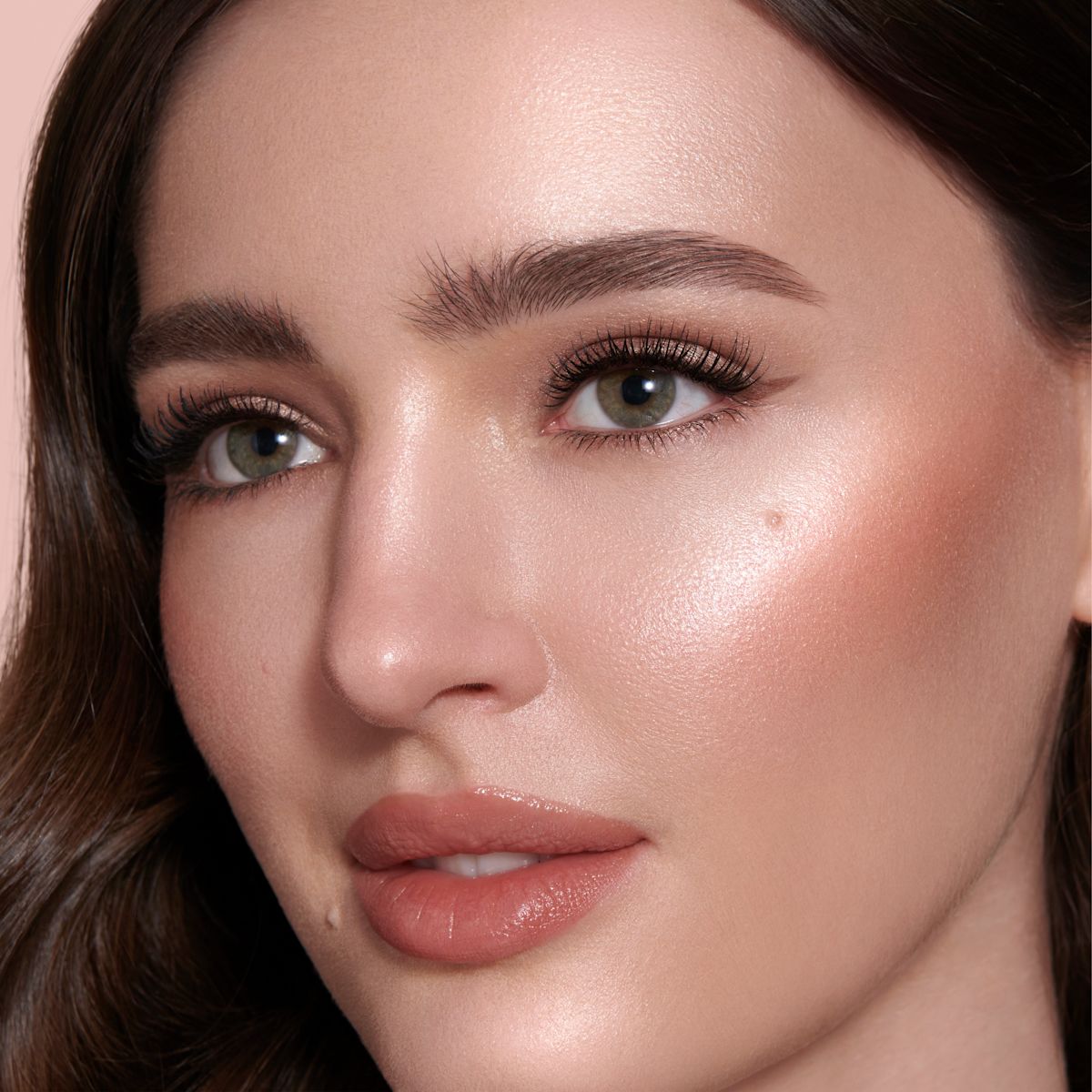 Beauty Light Wand in Peachgasm on medium-tone model