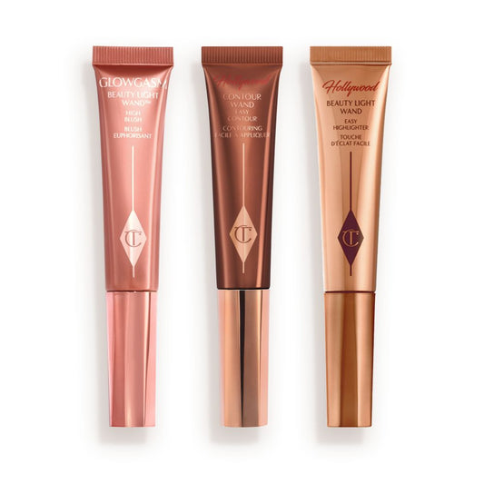Medium-pink liquid blush wand, glowy brown contour wand, and soft candlelight-gold-coloured liquid highlighter wand.