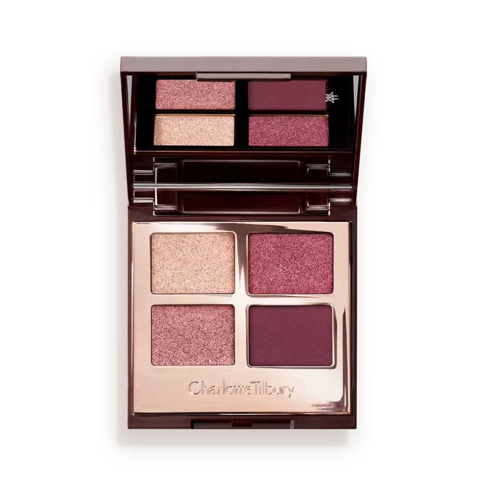 A mirrored-lid, quad eyeshadow palette with eyeshadows in shades of pink, plum, and champagne.