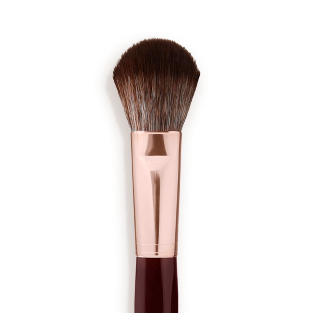 Close-up of a bronzer and blush brush with dark brown and grey bristles with a rose-gold and dark crimson handle.