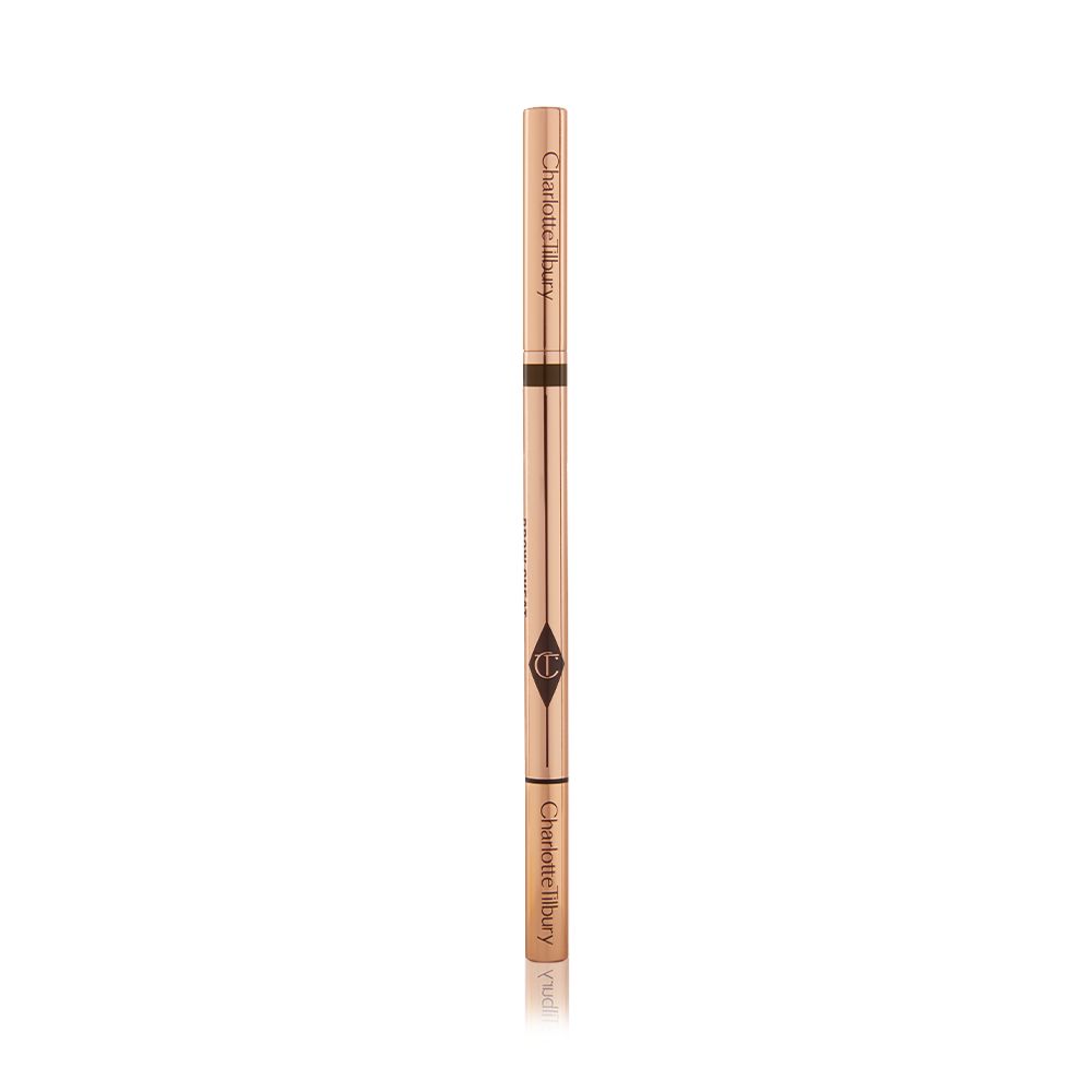 A closed, double-ended eyebrow pencil and spoolie brush duo with gold-coloured packaging.