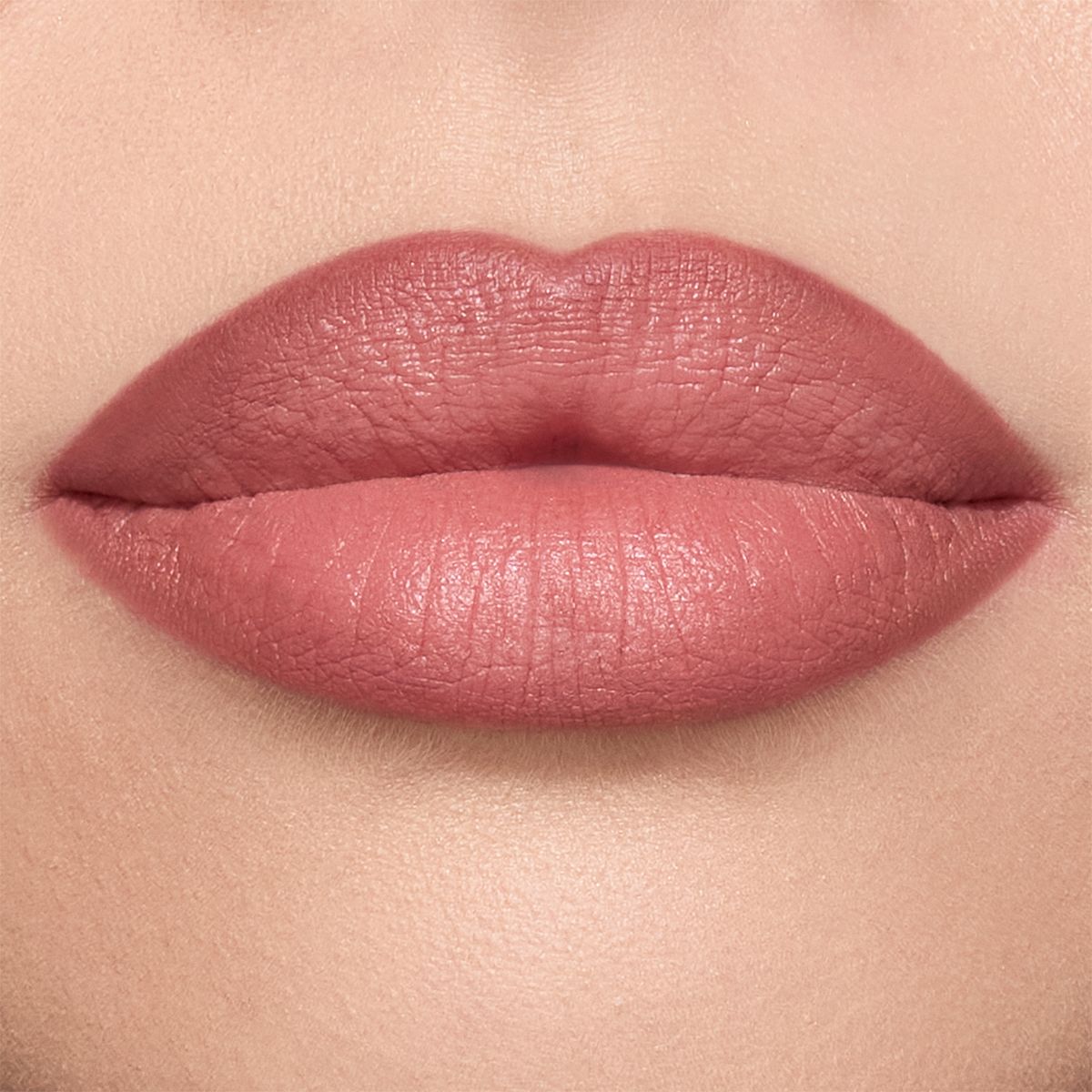 Close-up of a model's lips shaded a warm berry-pink.
