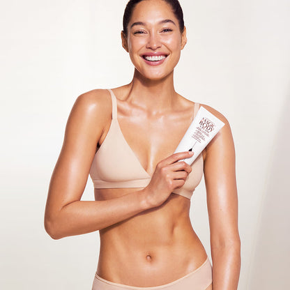 Fair skin model wearing and holding Magic Body Cream