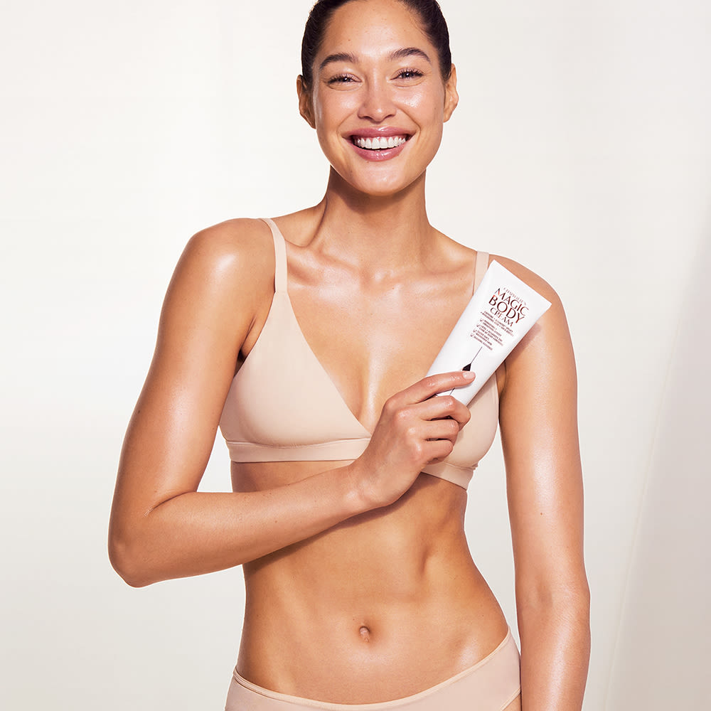 Fair skin model wearing and holding Magic Body Cream
