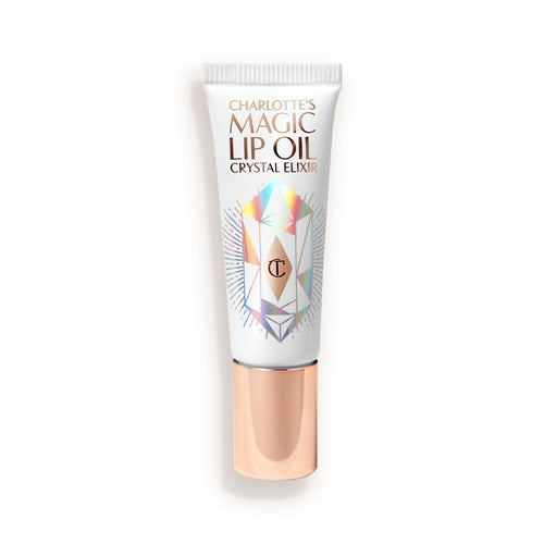 A lip oil in a white coloured tube with reflective geometric patterns on it in silver colour and a rose-gold-coloured lid.