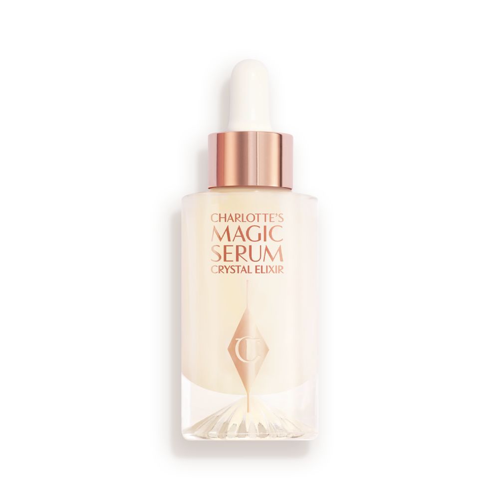 An award-winning, luminous, ivory-coloured serum in a glass bottle with a gold and white-coloured dropper lid.