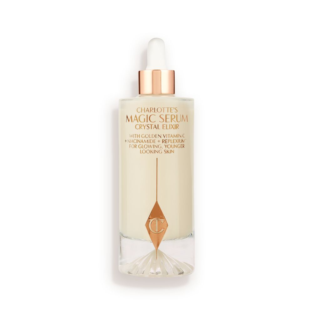 A luminous, ivory-coloured facial serum in a glass bottle with a white and gold-coloured dropper lid