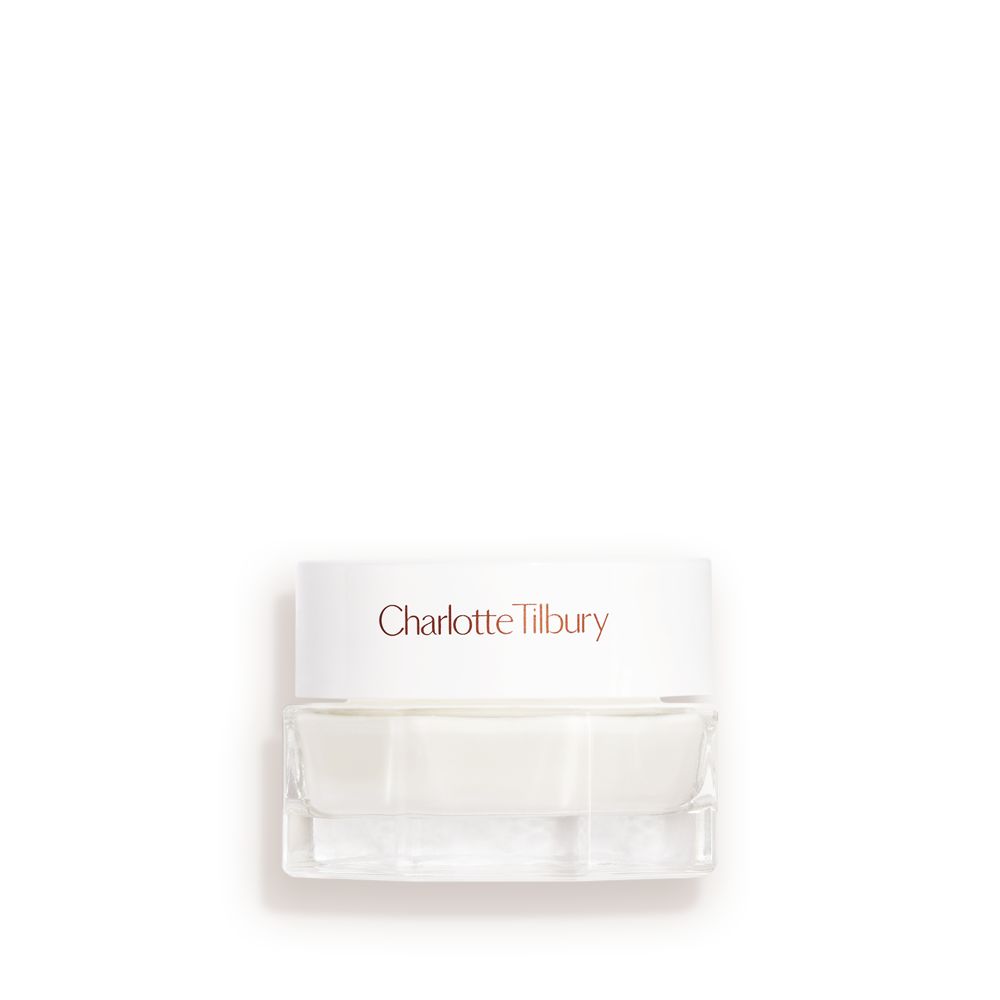 Mini clear jar with a white lid and white cream inside.