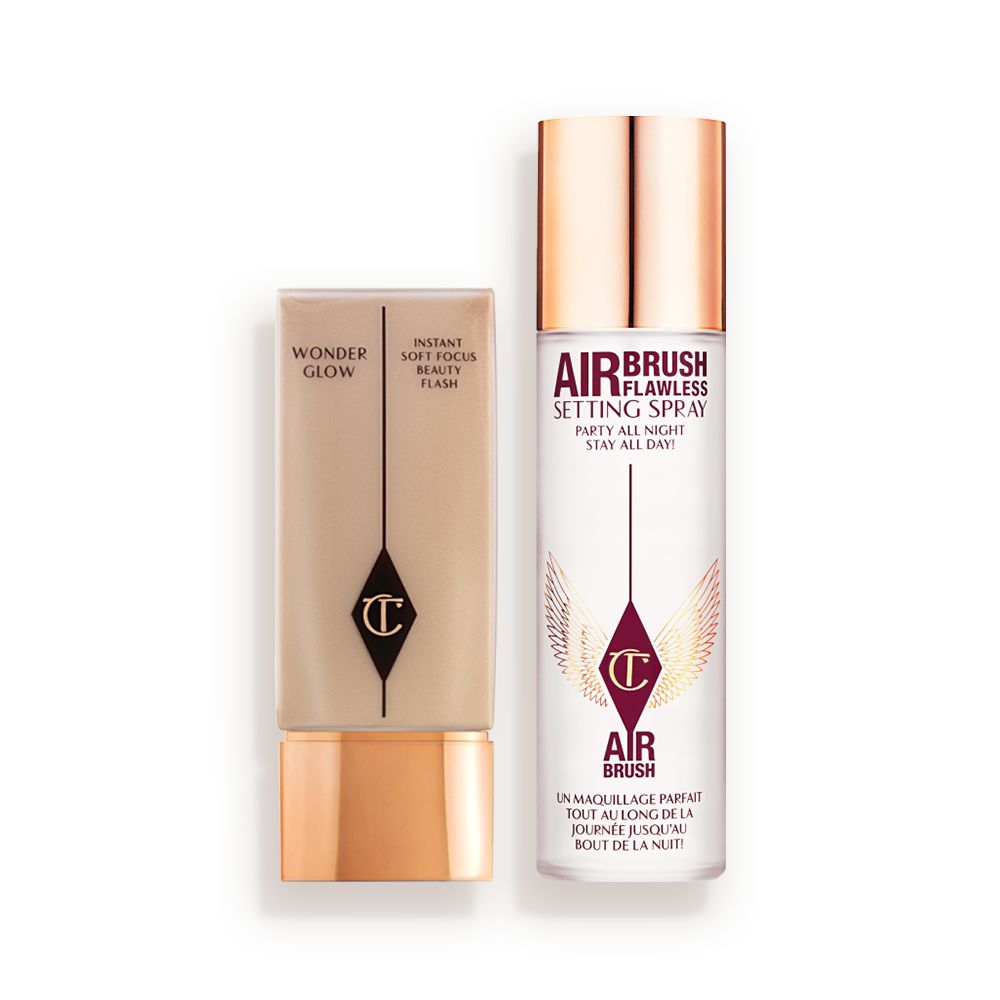 Foundation in a rectangular, clear bottle with a gold-coloured lid and setting spray in a large, clear bottle with a gold-coloured lid.