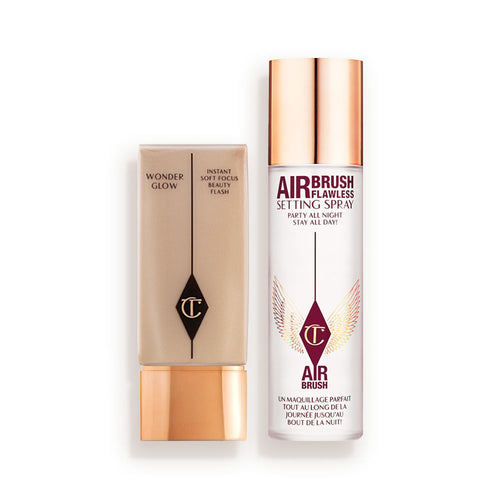 Foundation in a rectangular, clear bottle with a gold-coloured lid and setting spray in a large, clear bottle with a gold-coloured lid.