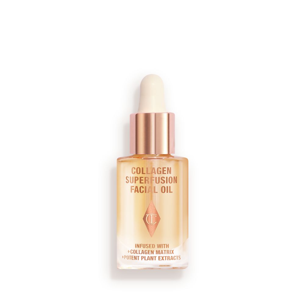 Travel-size light-gold-coloured facial oil in a glass bottle with a gold and white-coloured dropper lid.