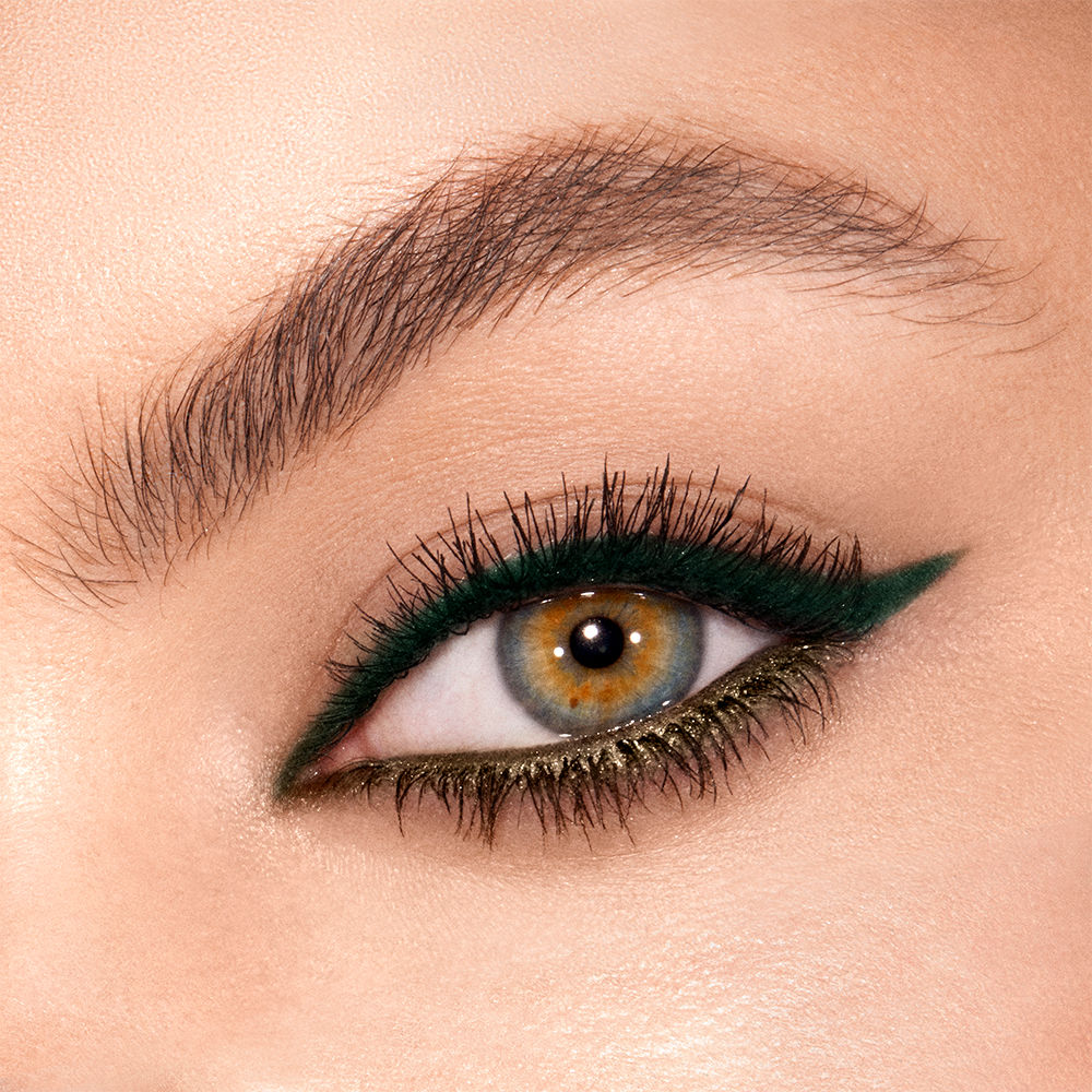 Fair-tone model with hazel eyes with a focus on dark green eyeliner on the upper lid and light green liner on the lower water line.