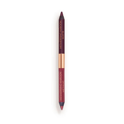 A double-ended eyeliner with lids removed with one side a bright maroon and the other a rich violet.