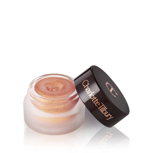 A golden pink duo-chrome-effect cream eyeshadow with a duo-chrome metallic finish in a petite, open glass pot with a dark brown lid.