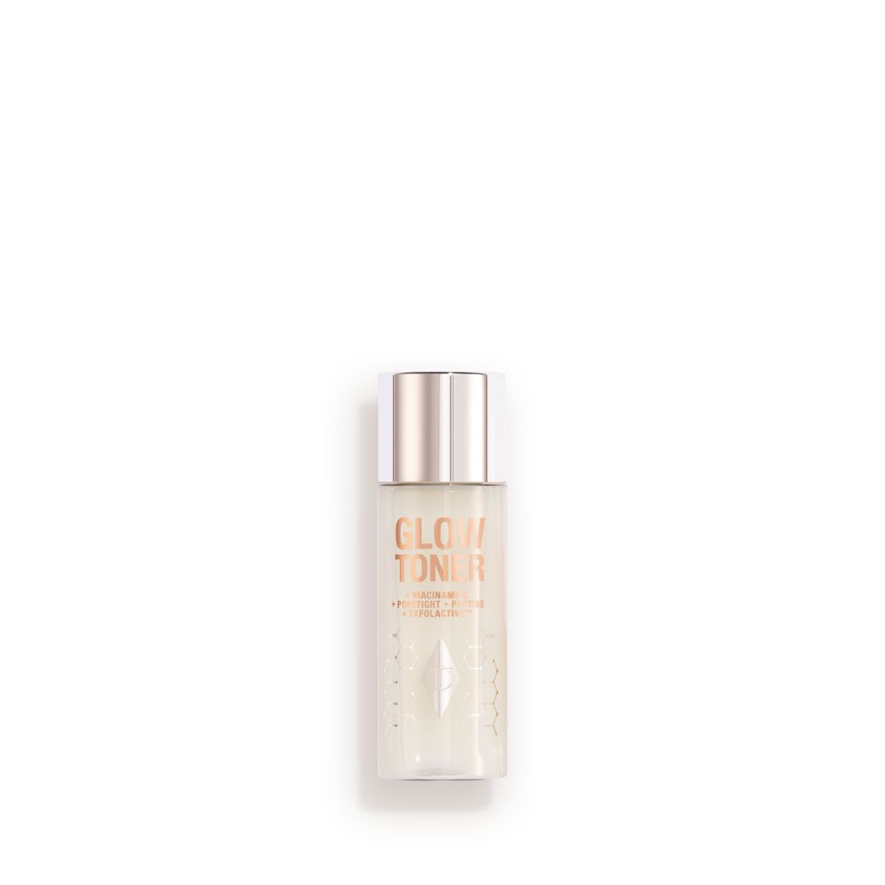 A large, clear bottle filled with luminous, cream-coloured watery toner with a silver-coloured lid.