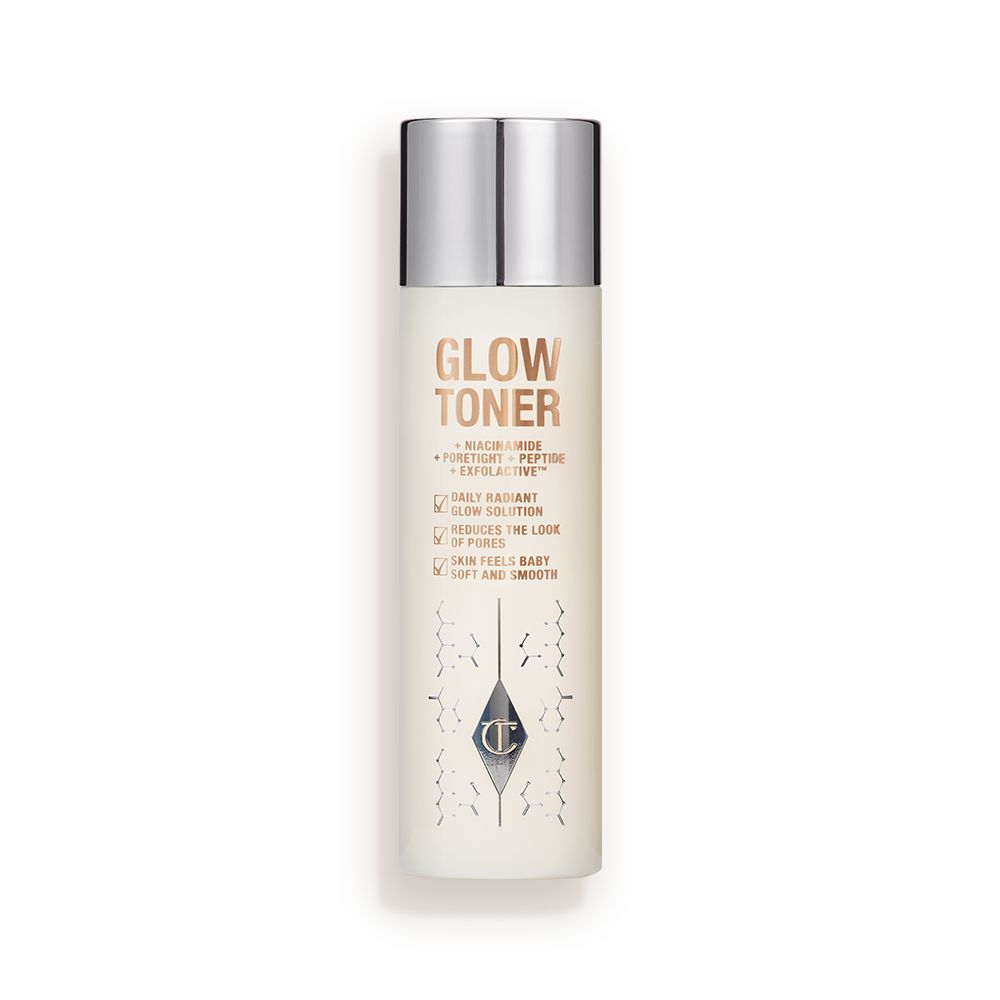 A large, clear bottle filled with luminous, cream-coloured watery toner with a silver-coloured lid.