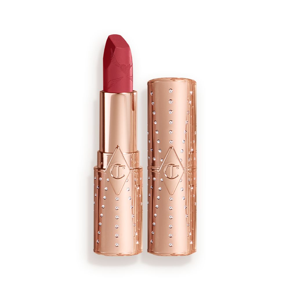 An open, blushed berry-rose lipstick in a metallic, golden-coloured tube with its lid next to it.