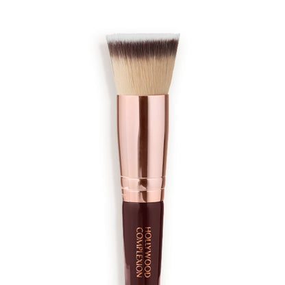 Close-up of a face blending contour brush with fawn, dark brown, and white-coloured bristles with rose-gold and dark crimson handle.